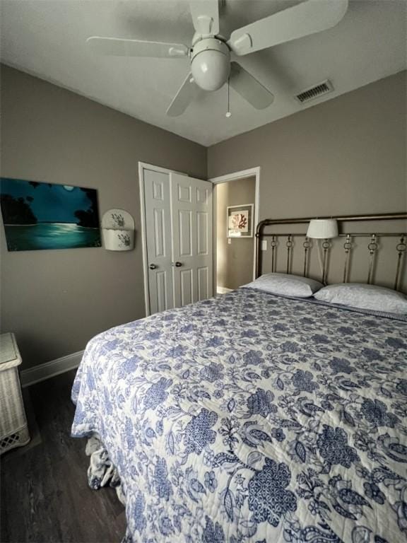 bedroom featuring wood finished floors, baseboards, and a ceiling fan