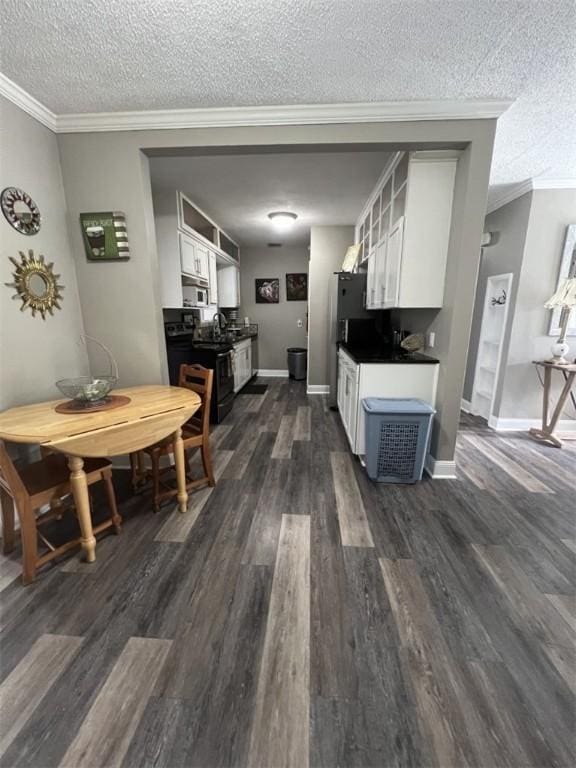 kitchen featuring ornamental molding, a textured ceiling, black electric range, dark wood-type flooring, and white cabinetry