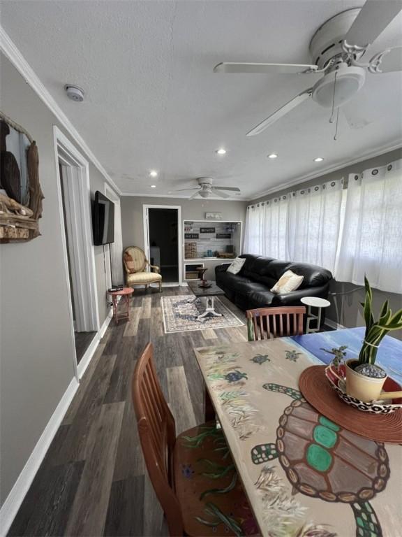 dining area featuring a ceiling fan, ornamental molding, wood finished floors, recessed lighting, and baseboards