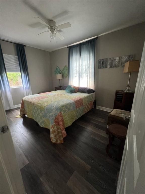 bedroom with baseboards, wood finished floors, and ceiling fan