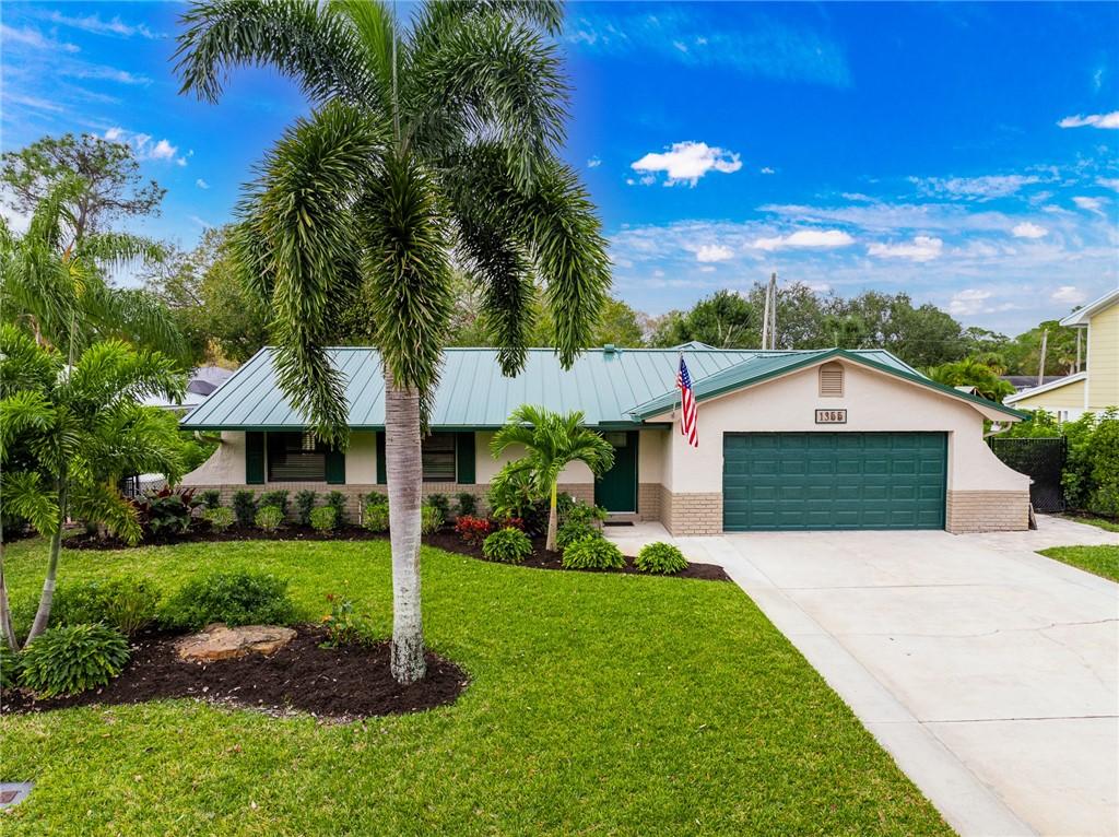 single story home featuring a garage and a front lawn