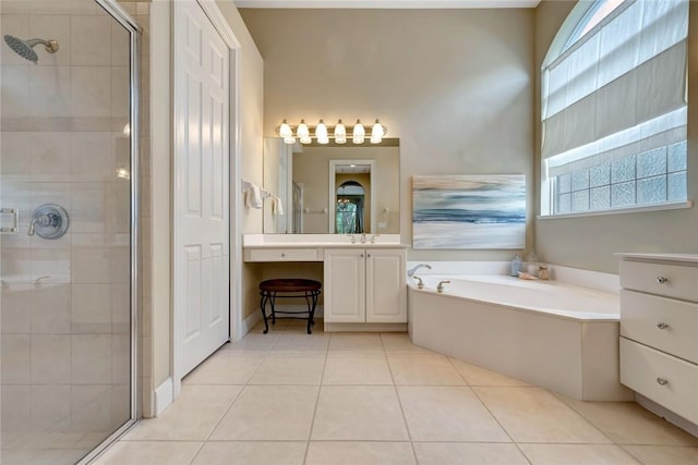 bathroom with vanity, tile patterned flooring, and plus walk in shower