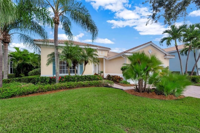 mediterranean / spanish house with a front lawn