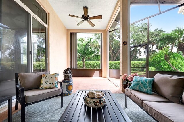 sunroom featuring ceiling fan, a healthy amount of sunlight, and lofted ceiling