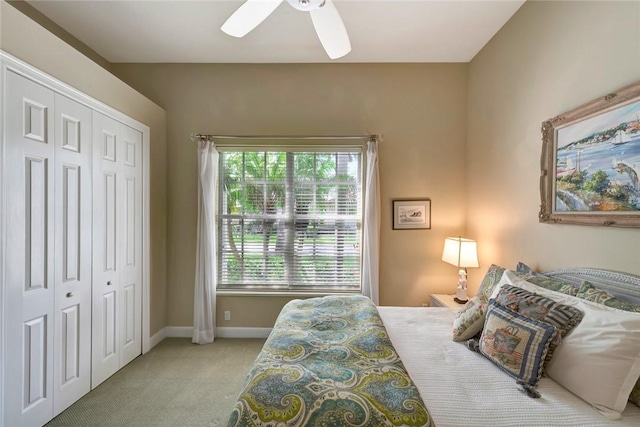 bedroom featuring light carpet, a closet, and ceiling fan