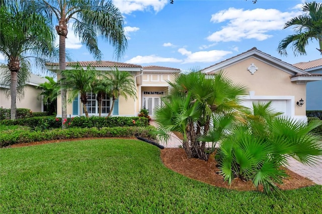 view of front of property featuring a front yard and a garage