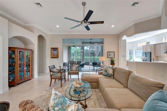 living room featuring ceiling fan, light tile patterned floors, and ornamental molding