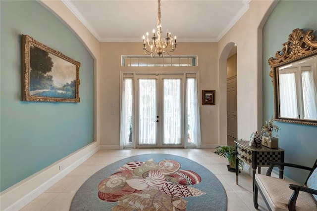 entrance foyer with french doors, light tile patterned floors, ornamental molding, and a notable chandelier