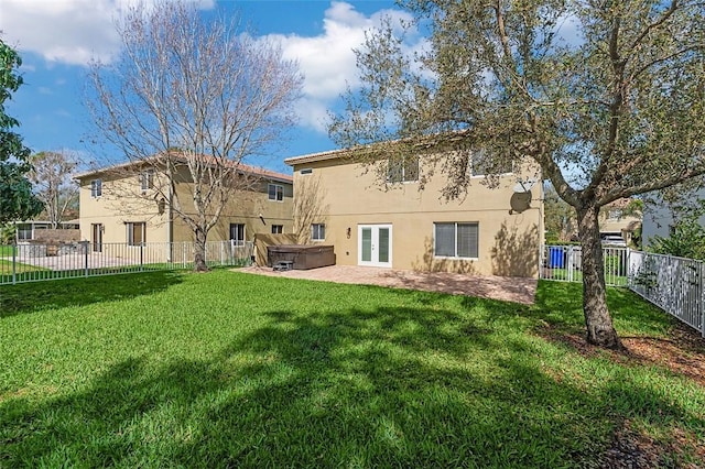 4455 55th St, Vero Beach, FL 32967 - rear view of property with a hot tub, stucco siding, french doors, a fenced backyard, and a patio