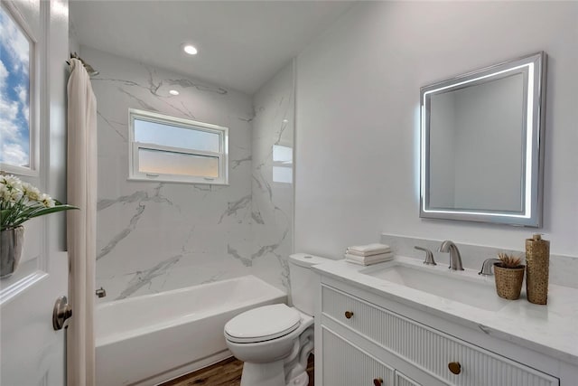 full bath featuring toilet, recessed lighting, washtub / shower combination, and vanity