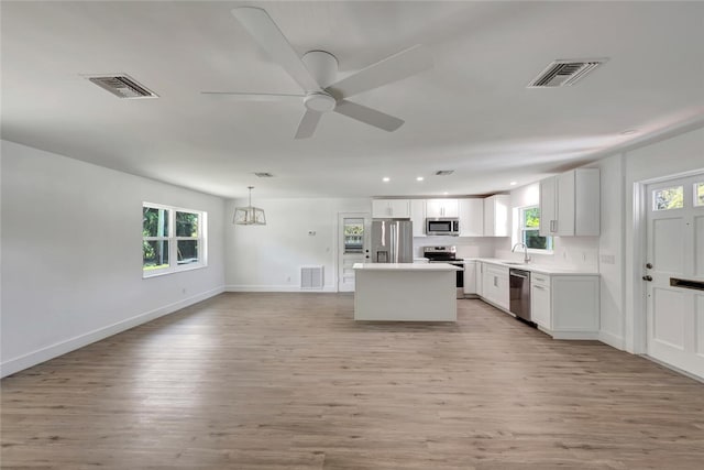 kitchen featuring stainless steel appliances, visible vents, and a sink