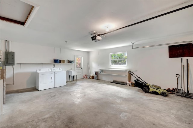 garage with washing machine and dryer, electric panel, a sink, and a garage door opener