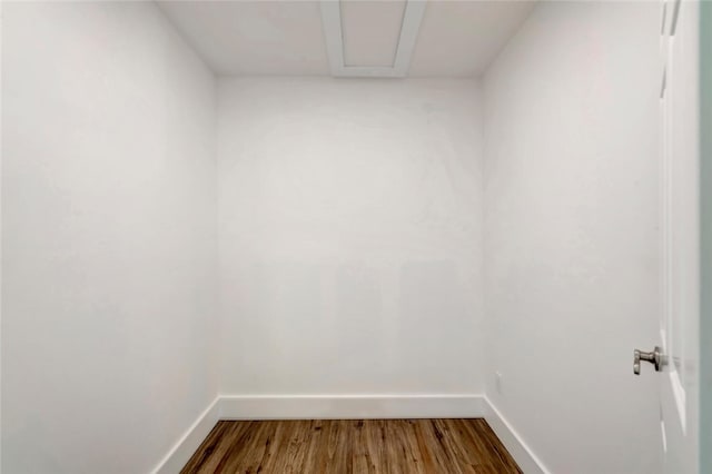 interior space with baseboards and wood finished floors