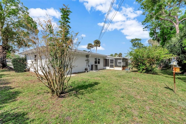 view of yard featuring central AC and a sunroom