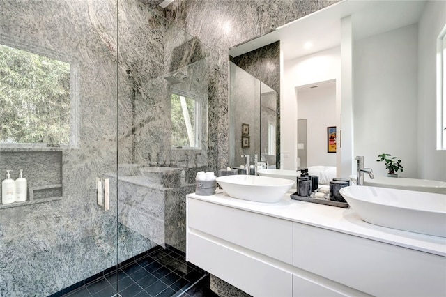 bathroom featuring tile walls, an enclosed shower, and vanity