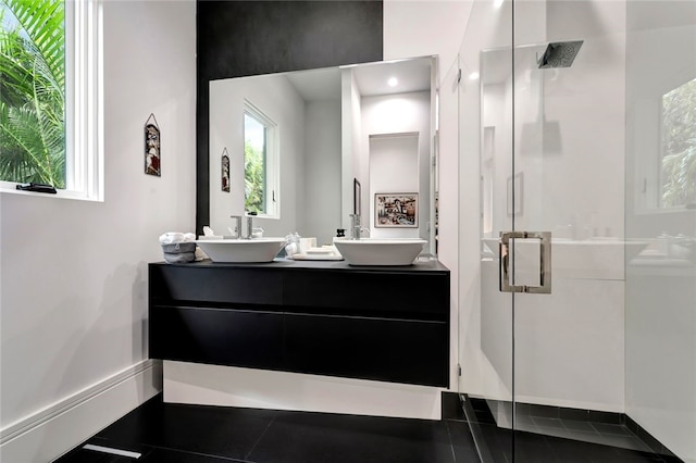 bathroom featuring vanity and a shower with door