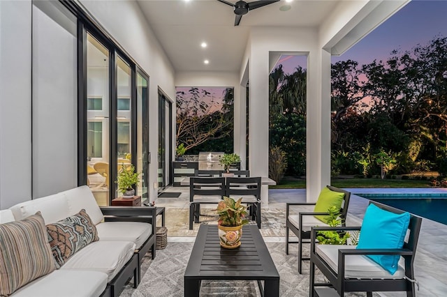 patio terrace at dusk featuring an outdoor living space, area for grilling, and ceiling fan