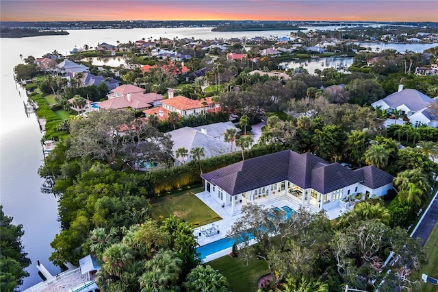 aerial view at dusk with a water view