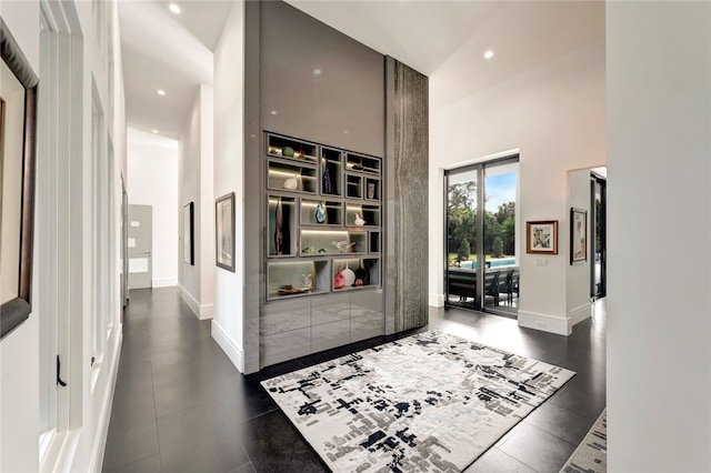 hallway featuring a high ceiling