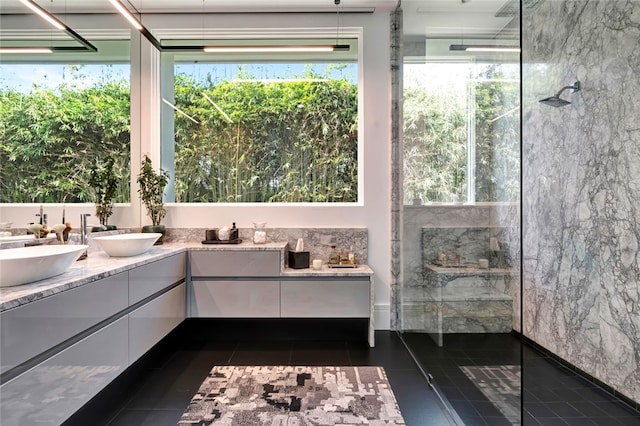 bathroom featuring tile patterned floors, vanity, and walk in shower