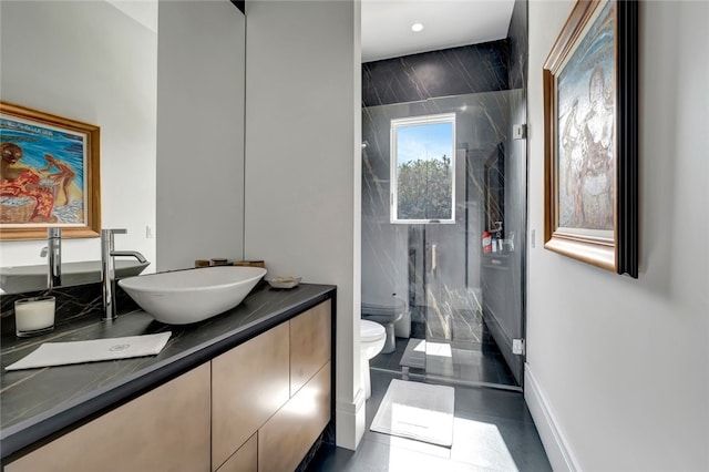 bathroom with toilet, vanity, and a bidet