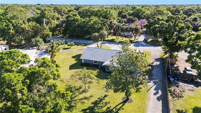 bird's eye view with a wooded view