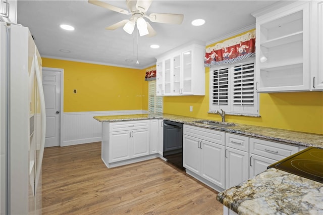 kitchen featuring a peninsula, a sink, white cabinets, black dishwasher, and white refrigerator with ice dispenser