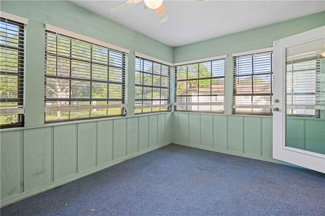 unfurnished sunroom with ceiling fan