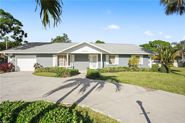 ranch-style house with a front lawn, an attached garage, concrete driveway, and stucco siding