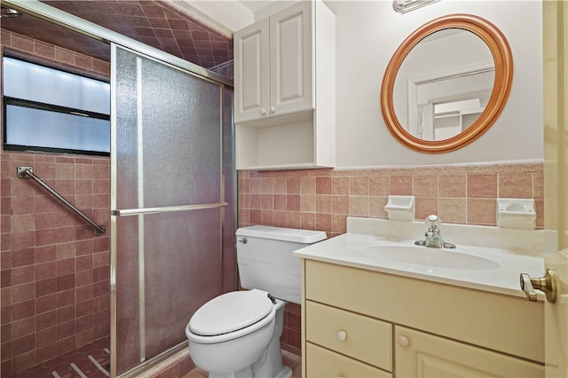 full bathroom with toilet, tile walls, a stall shower, and vanity