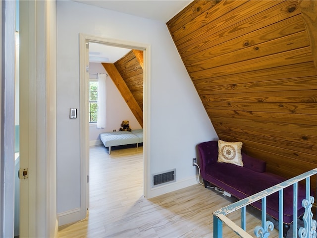 bedroom with lofted ceiling, light hardwood / wood-style floors, and wooden ceiling