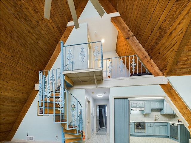 stairway featuring high vaulted ceiling, sink, wood ceiling, and beam ceiling