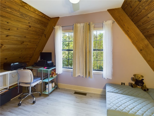 office space featuring ceiling fan, lofted ceiling, and light hardwood / wood-style flooring