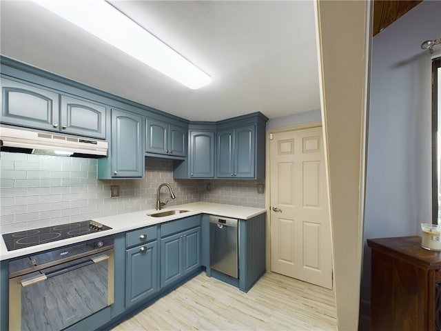 kitchen featuring blue cabinets, sink, black electric cooktop, dishwasher, and oven