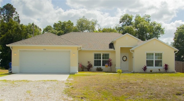 single story home featuring a front yard and a garage