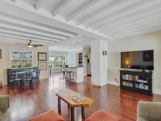 living area with beam ceiling, baseboards, ceiling fan, dark wood-style floors, and recessed lighting