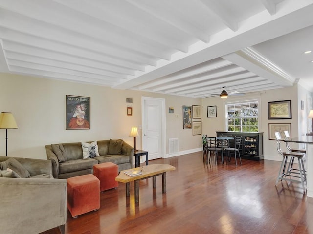 living room featuring beam ceiling, dark wood-type flooring, and ceiling fan