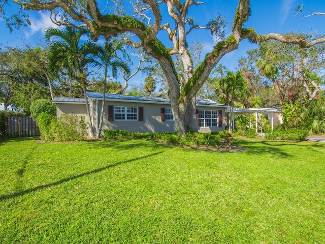 back of house featuring a lawn