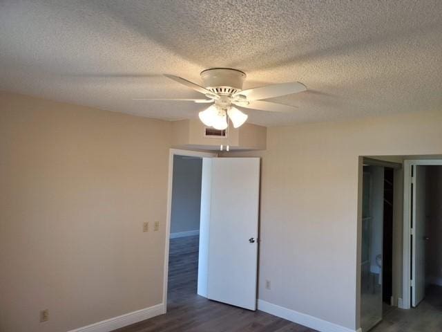 30 Plantation Dr Unit 104, Vero Beach, FL 32966 - unfurnished bedroom with wood finished floors, baseboards, a textured ceiling, and ceiling fan