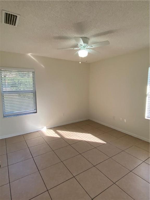 473 Englar Dr, Sebastian, FL 32958 - spare room with light tile patterned flooring, a ceiling fan, and a textured ceiling