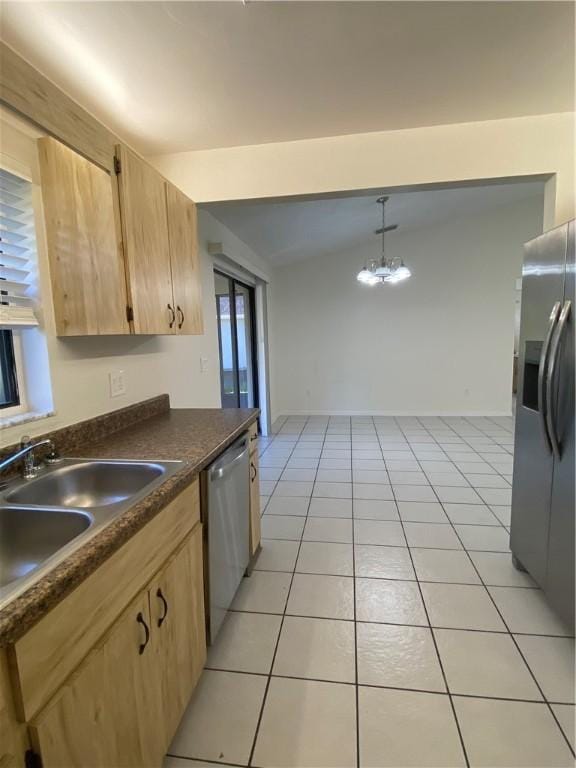 473 Englar Dr, Sebastian, FL 32958 - kitchen with stainless steel appliances, dark countertops, vaulted ceiling, light brown cabinets, and light tile patterned flooring