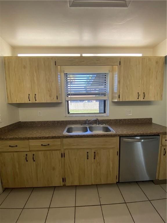 473 Englar Dr, Sebastian, FL 32958 - kitchen featuring stainless steel dishwasher, light brown cabinetry, dark countertops, and light tile patterned flooring