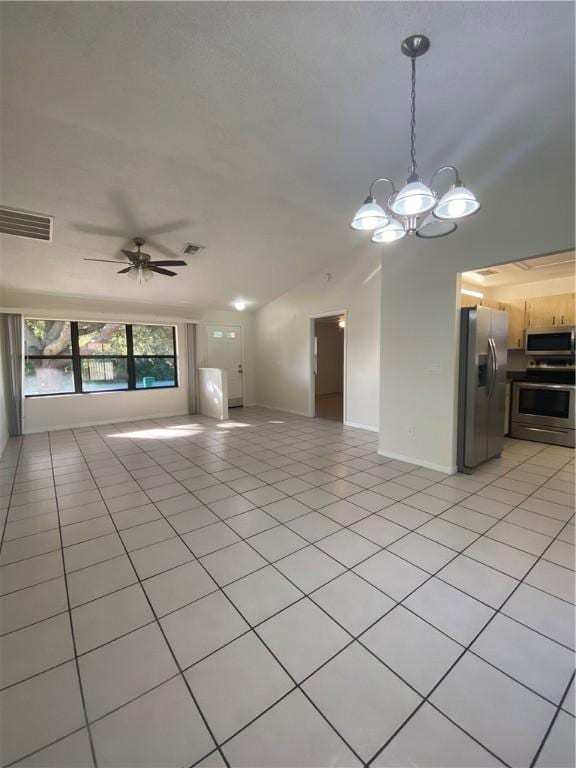473 Englar Dr, Sebastian, FL 32958 - unfurnished living room featuring a chandelier, light tile patterned floors, a ceiling fan, and vaulted ceiling