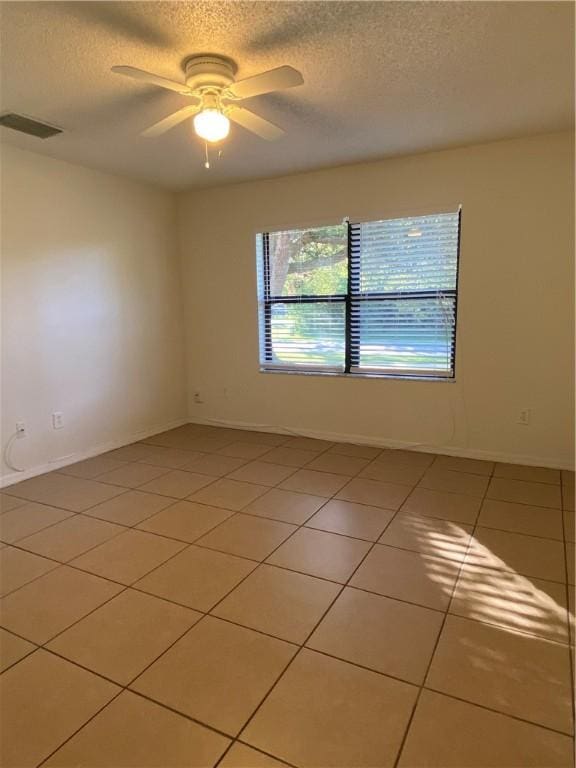 473 Englar Dr, Sebastian, FL 32958 - spare room with a textured ceiling, a ceiling fan, and light tile patterned flooring