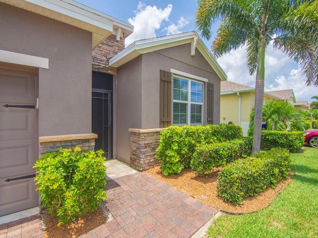 2641 Crowned Eagle Cir SW, Vero Beach, FL 32962 - property entrance with stucco siding and stone siding