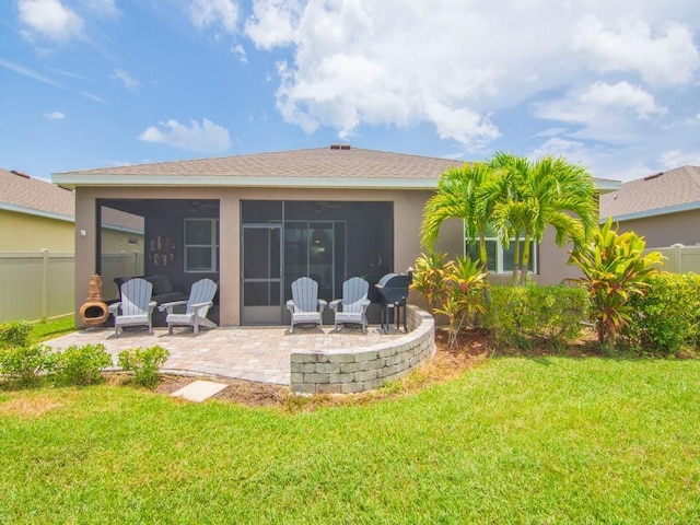2641 Crowned Eagle Cir SW, Vero Beach, FL 32962 - back of property with a patio, a sunroom, stucco siding, and roof with shingles