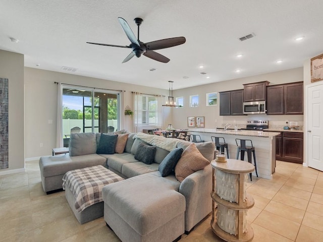 2641 Crowned Eagle Cir SW, Vero Beach, FL 32962 - living room with a ceiling fan, light tile patterned floors, a chandelier, and recessed lighting