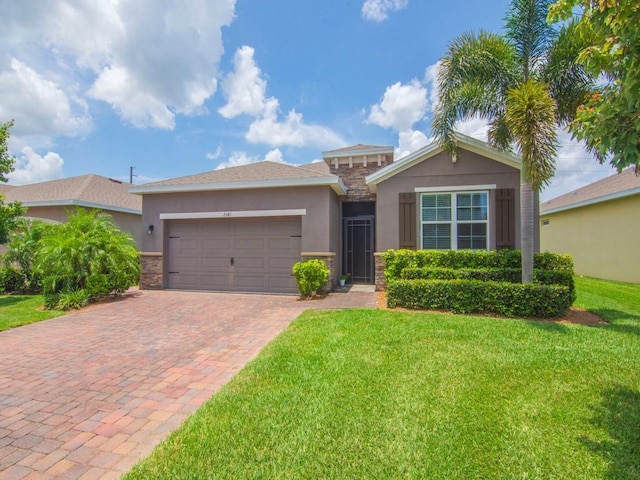 2641 Crowned Eagle Cir SW, Vero Beach, FL 32962 - view of front of house featuring stucco siding, a garage, stone siding, decorative driveway, and a front lawn