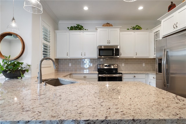 kitchen with light stone countertops, white cabinetry, sink, hanging light fixtures, and stainless steel appliances