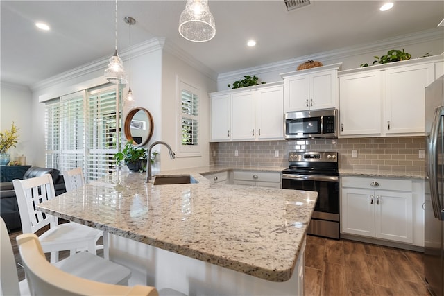 kitchen featuring sink, stainless steel appliances, decorative light fixtures, decorative backsplash, and white cabinets